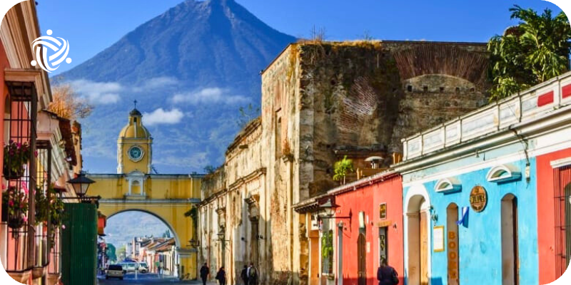 colorful buildings in front of a mountain in guatemala
